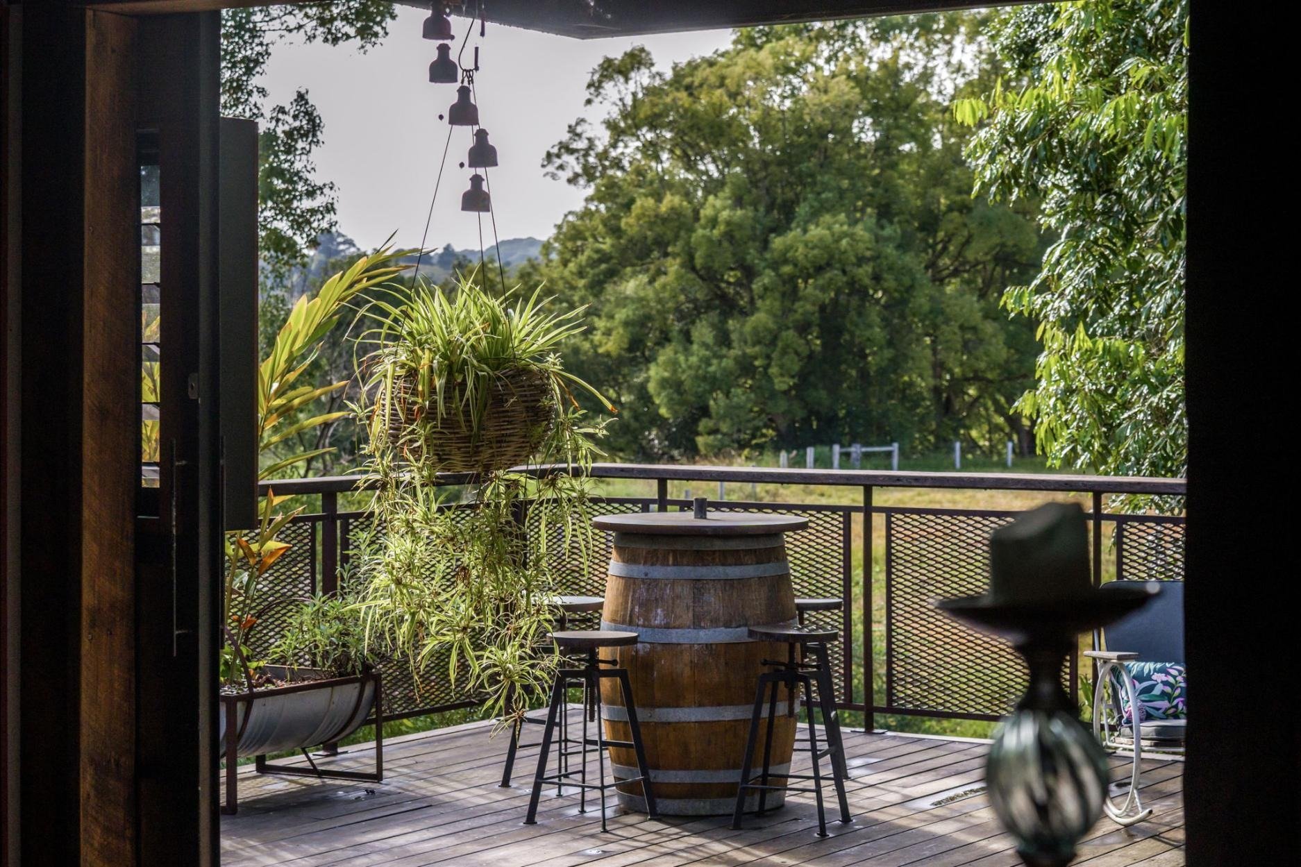 the deck with the wine-barrel table, looking out