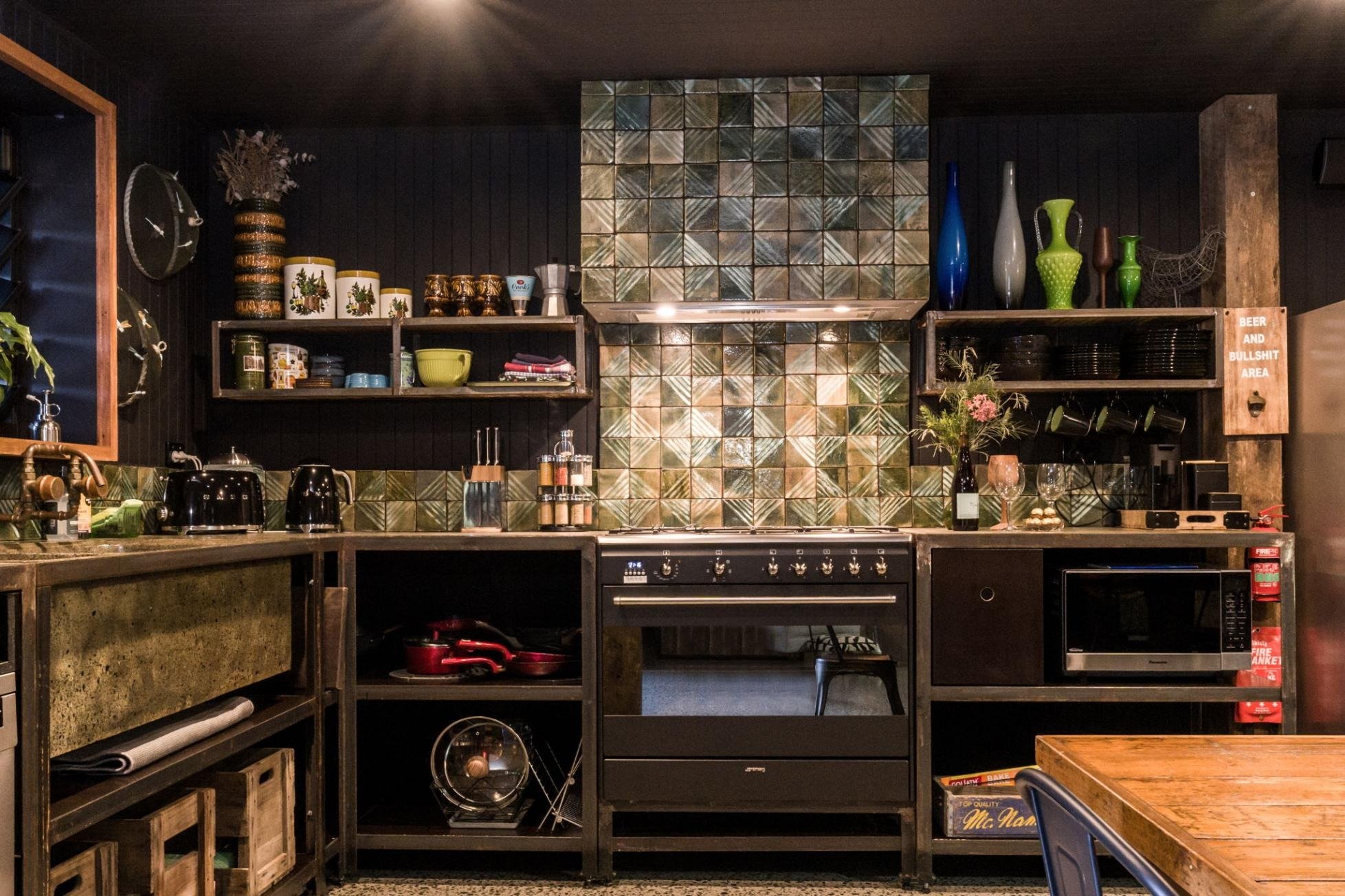the kitchen in moody timber and brass